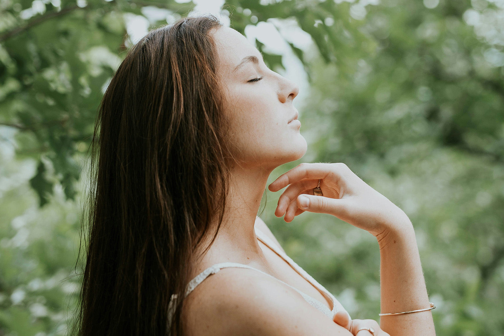 woman with eyes closed in nature