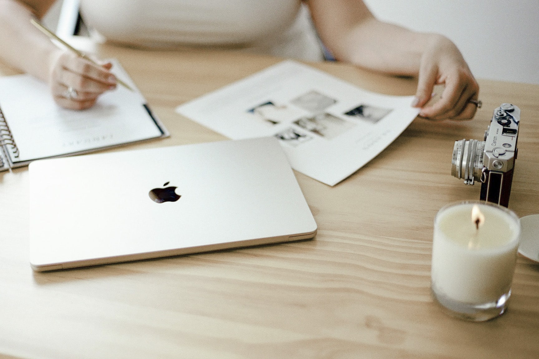 woman writing in a planner at desk