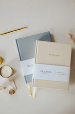 Load image into Gallery viewer, Engagement and Marriage Journal on white surface with candle and pen