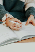 Load image into Gallery viewer, Woman writing in the Engagement Journal