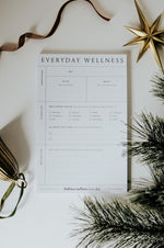 Load image into Gallery viewer, Everyday Wellness Notepad on white background with decorative elements