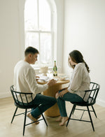 Load image into Gallery viewer, A couple sitting at a table in a bright room journaling together