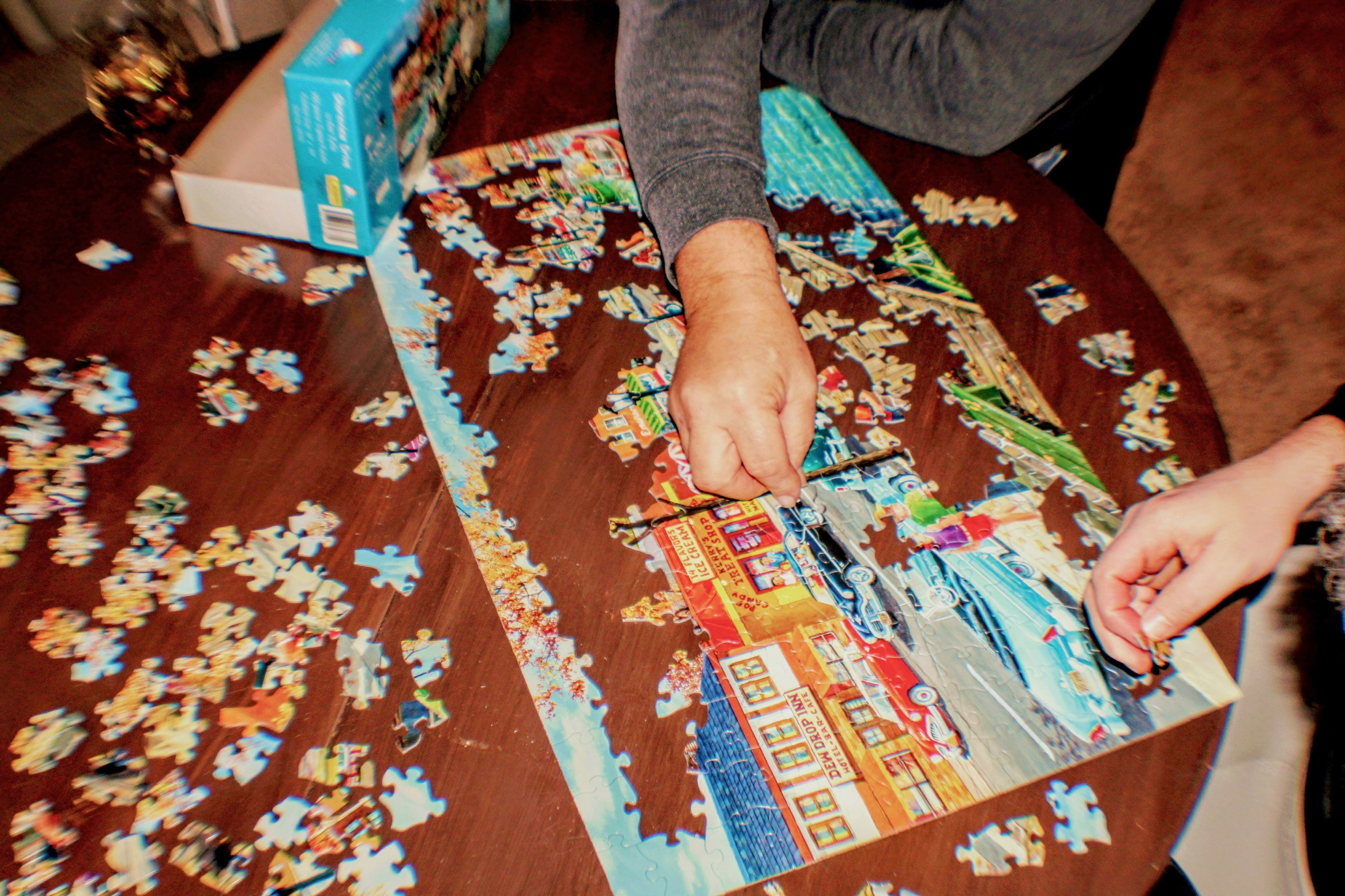 two people doing a jigsaw puzzle