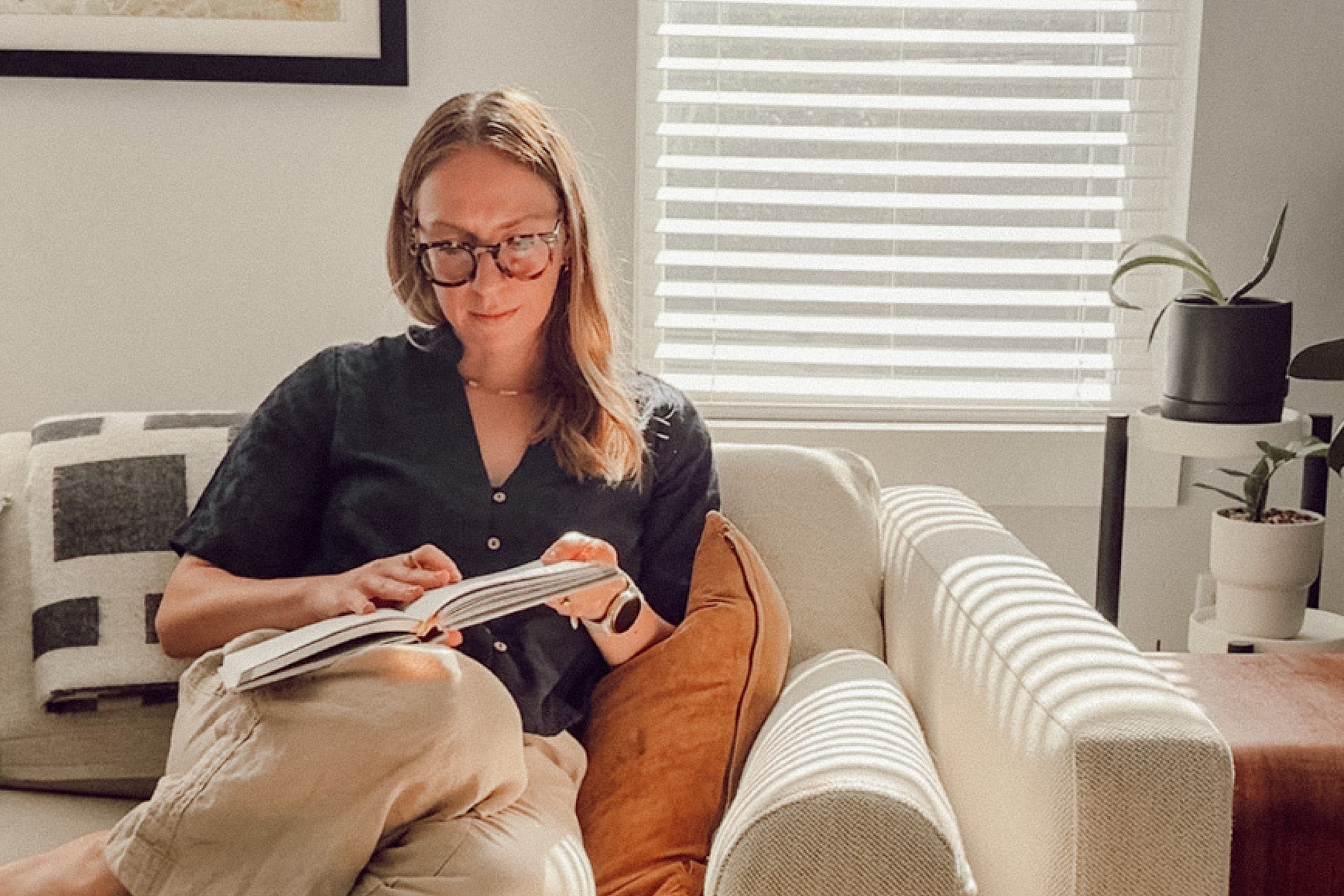 woman on couch with journal