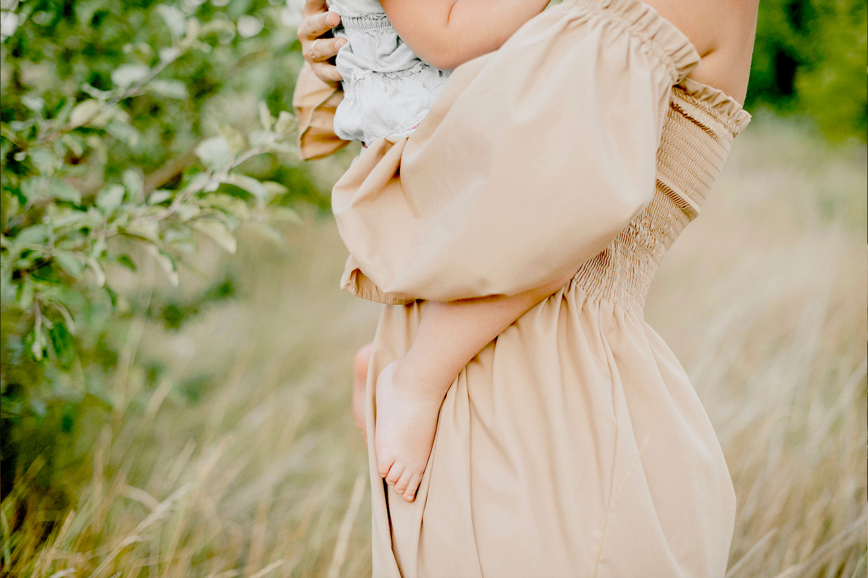 mom and baby in grassy field