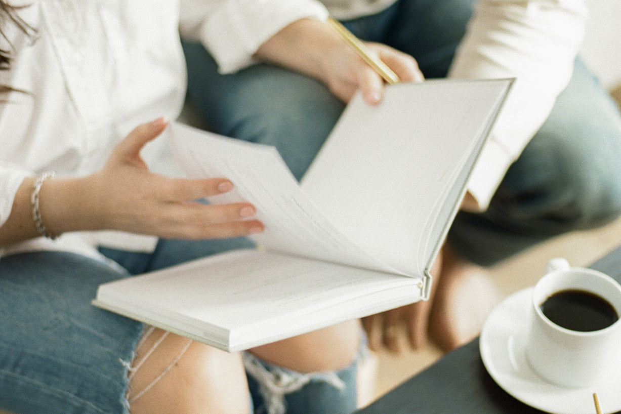 couple journaling on couch