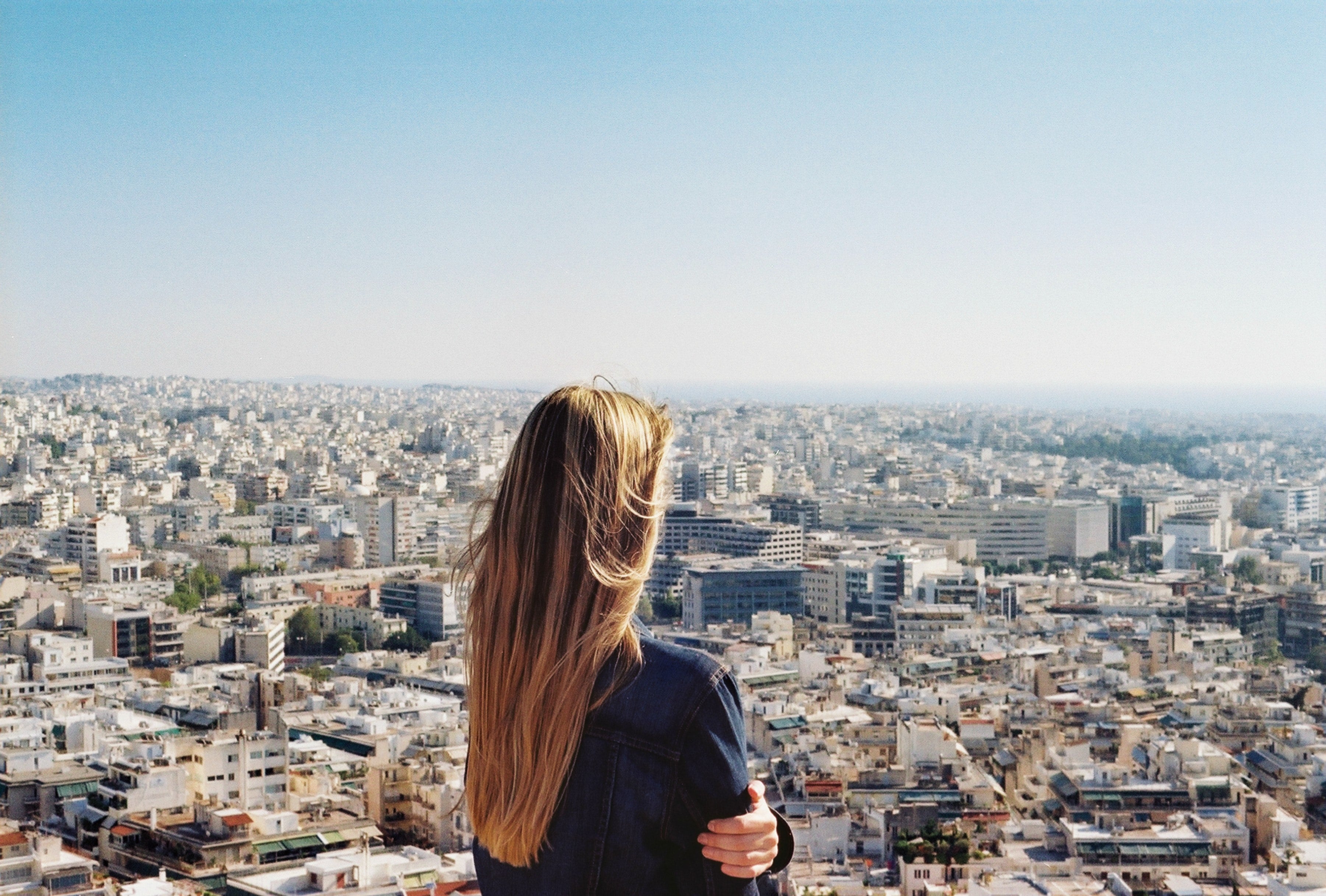 Young woman looking longingly out over city