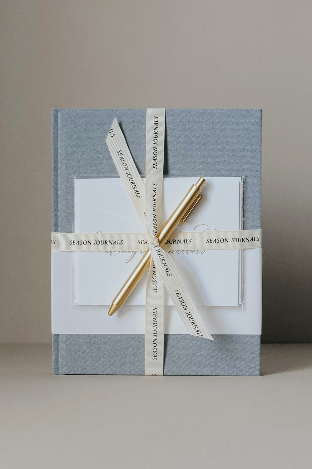 Engagement journal with ribbon, card, and gold pen