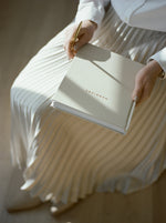Load image into Gallery viewer, Woman holding the Marriage Journal and gold pen with ray of light hitting the journal.
