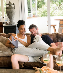 Engaged couple relaxing at home with The Engagement Journal 