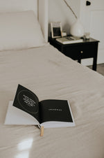 Load image into Gallery viewer, Everyday Positive Journal on linen blanket in bedroom
