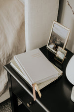 Load image into Gallery viewer, Everyday Positive Journal on nightstand with books and decor
