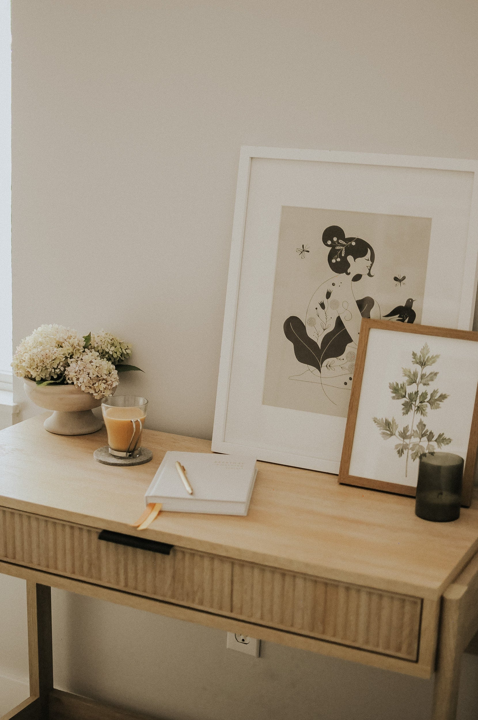 Everyday Positive Journal on desk with coffee, flowers, candle, decor