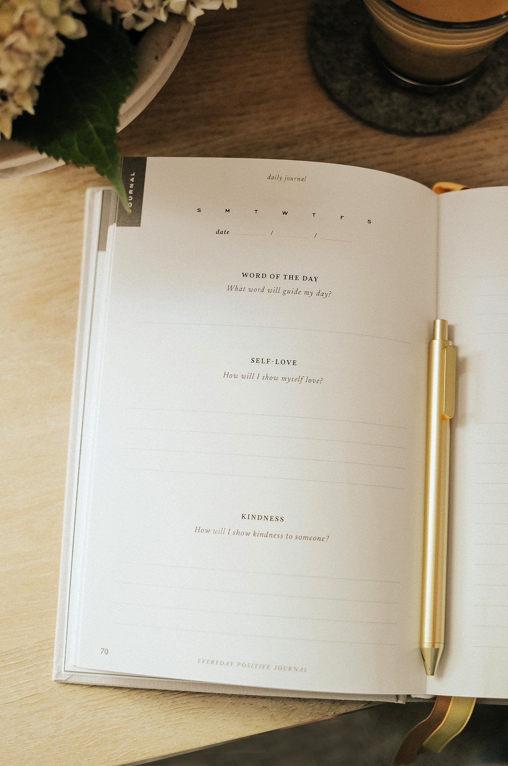 Everyday Positive Journal open on desk with coffee and flowers