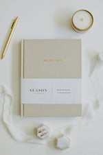 Load image into Gallery viewer, Marriage Journal cover with a pen and candle on a light surface
