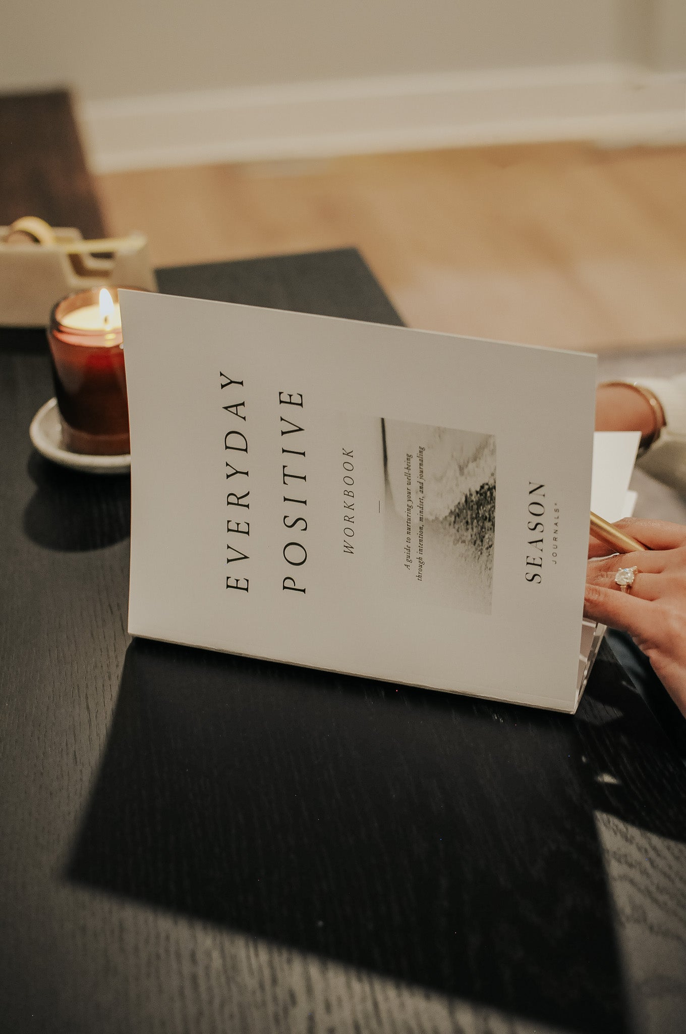 Everyday Positive Workbook on desk with candle