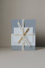 Load image into Gallery viewer, Slate blue engagement journal with congratulations card, gold pen, wrapped in ribbon
