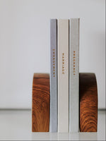 Load image into Gallery viewer, Three journals titled 'Engagement', 'Marriage', and 'Pregnancy' on wooden bookends against a plain background.
