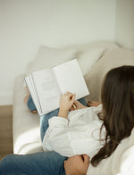 Load image into Gallery viewer, Woman on couch looking at Engagement Journal

